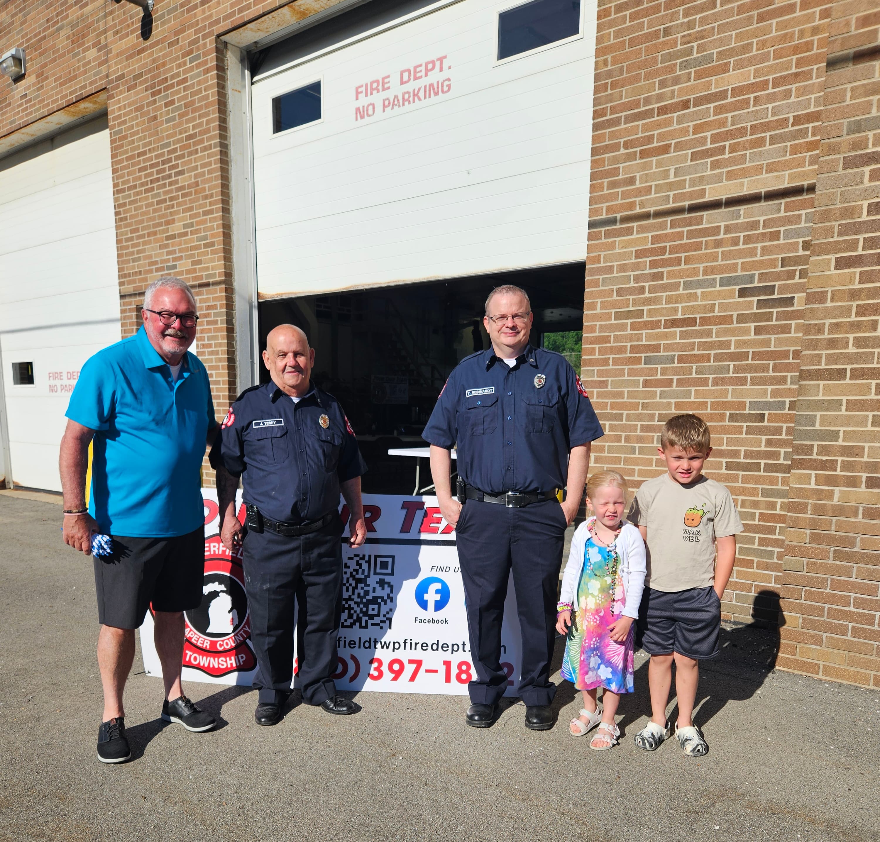 Dave Richardson with first responders and children outside a local fire department