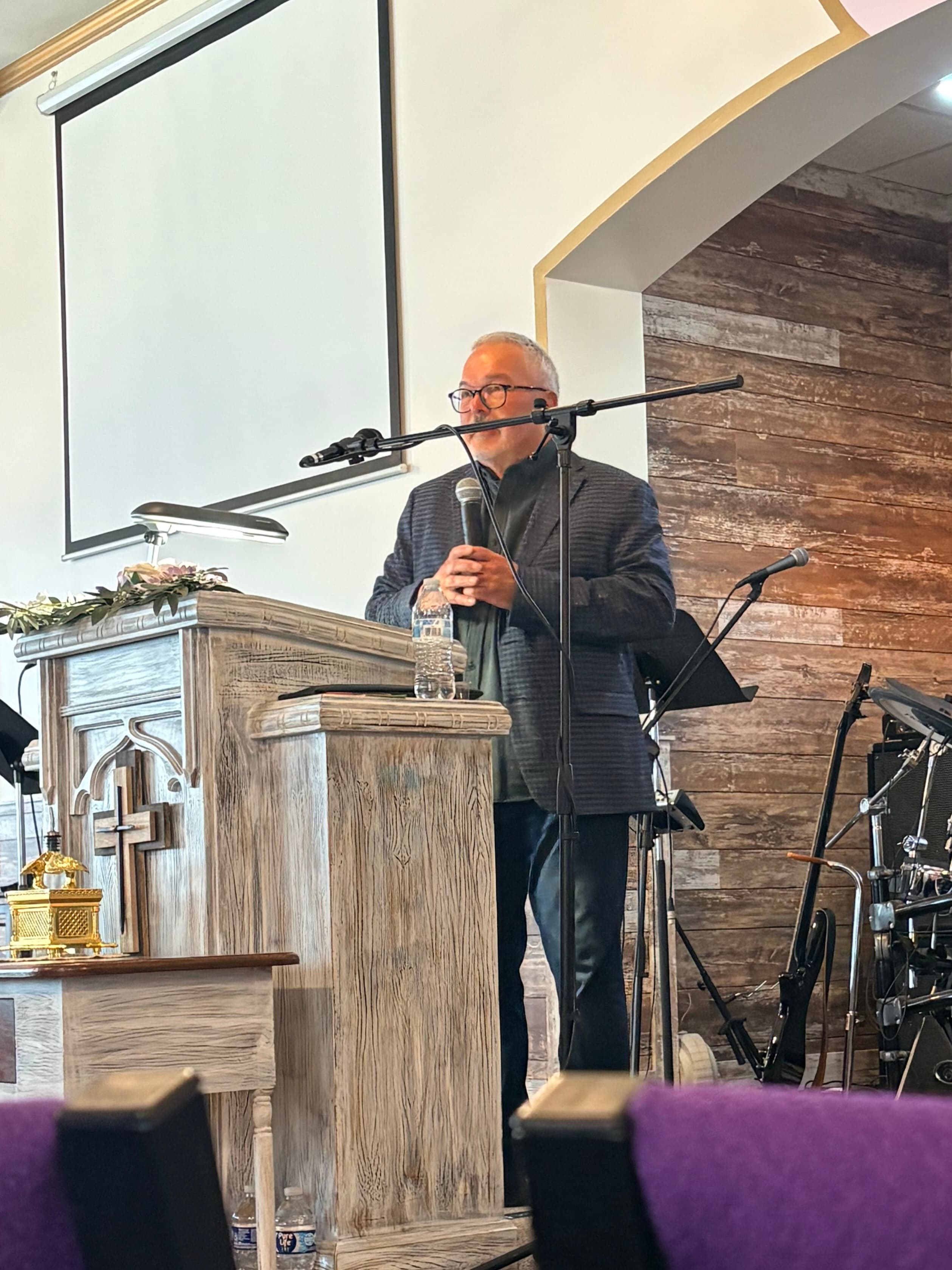 Dave Richardson speaking at a church podium